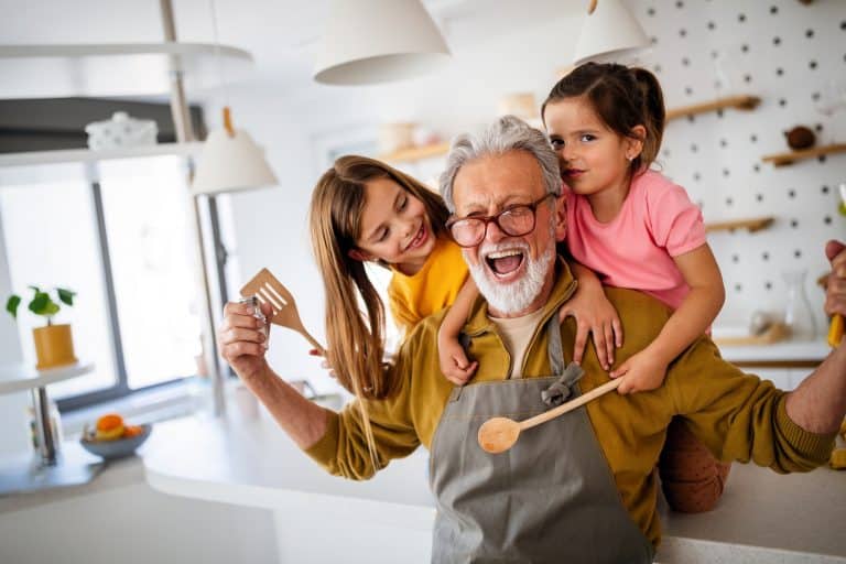 Portuguese Nationality for Grandchildren: Happy grandparent playing, having fun with grandchildren